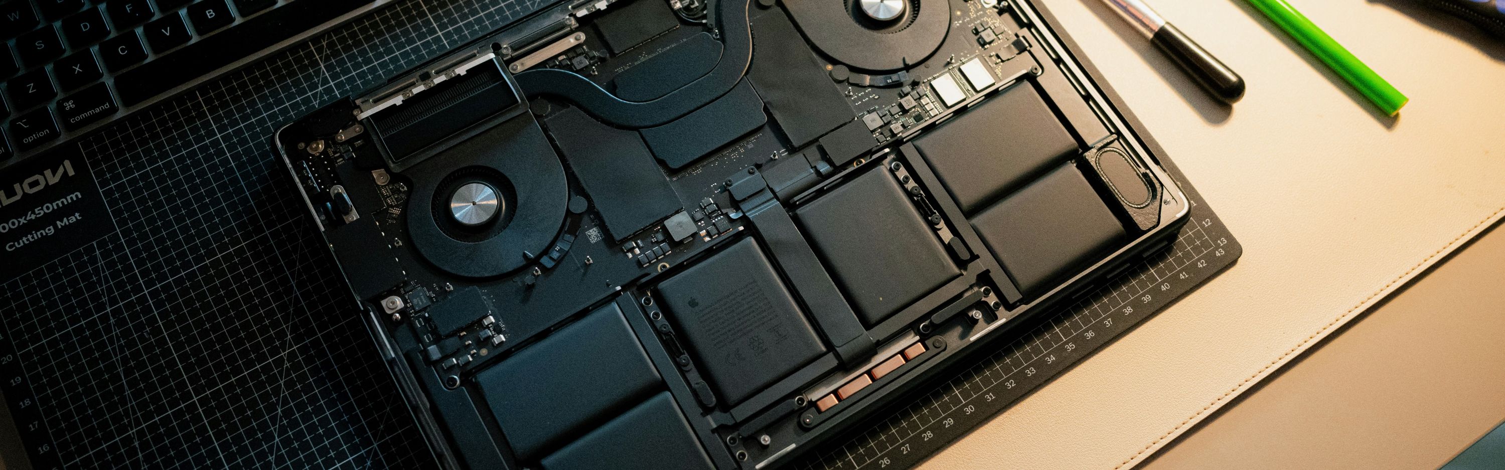 Apple repair at iMac and More: an opened MacBook on the workbench with repair tools