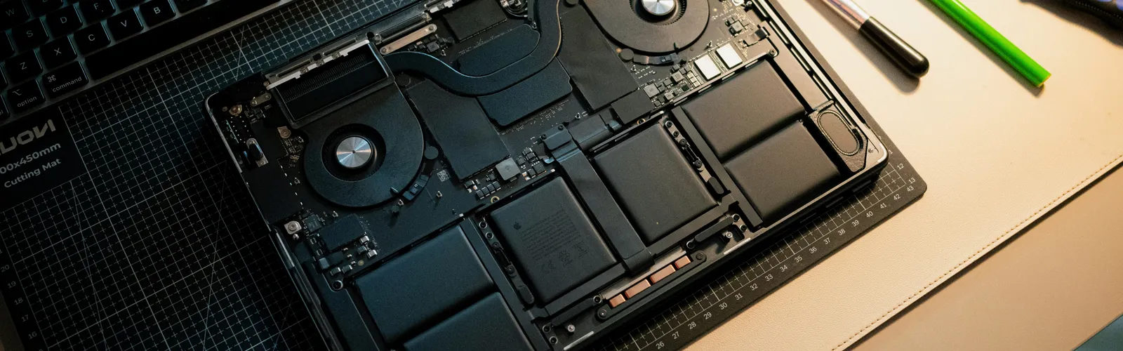 Apple repair at iMac and More: an opened MacBook on the workbench with repair tools